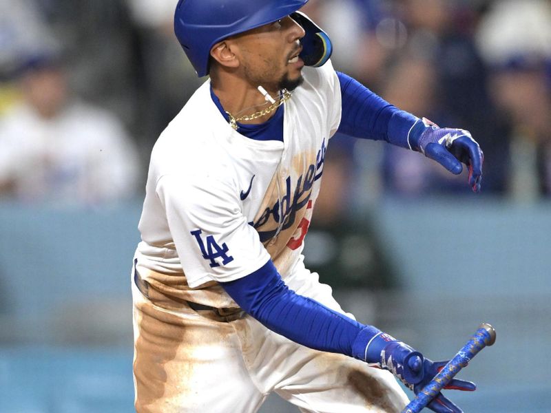 Apr 2, 2024; Los Angeles, California, USA; Los Angeles Dodgers shortstop Mookie Betts (50) watches the flight of the ball on a solo home run for his 1500th career hit in the third inning against the San Francisco Giants at Dodger Stadium. Mandatory Credit: Jayne Kamin-Oncea-USA TODAY Sports