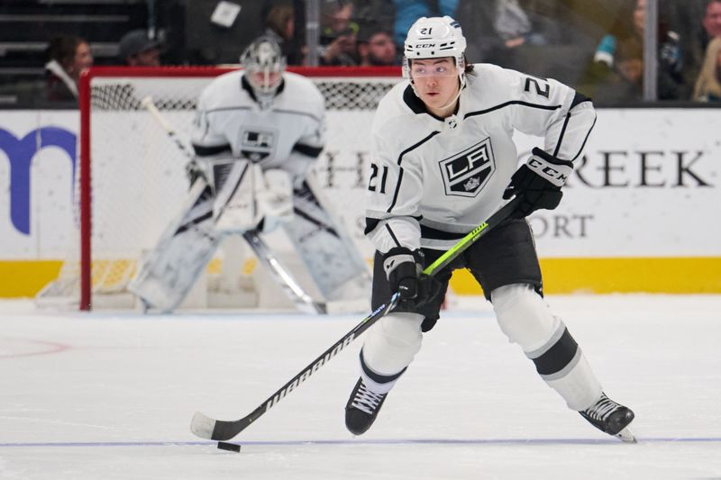 Apr 4, 2024; San Jose, California, USA; Los Angeles Kings defenseman Jordan Spence (21) plays the puck against against the San Jose Sharks during the third period at SAP Center at San Jose. Mandatory Credit: Robert Edwards-USA TODAY Sports