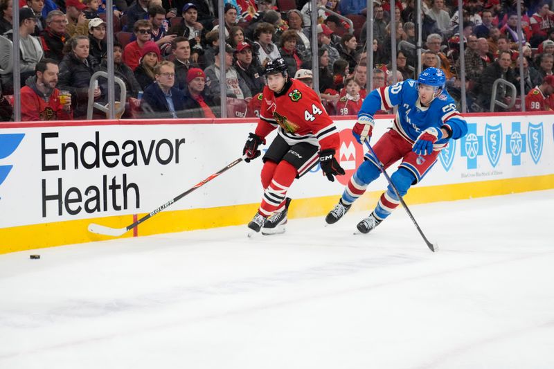 Dec 10, 2025; Chicago, Illinois, USA; New York Rangers left wing Will Cuylle (50) defends Chicago Blackhawks defenseman Wyatt Kaiser (44) during the third period at United Center. Mandatory Credit: David Banks-Imagn Images