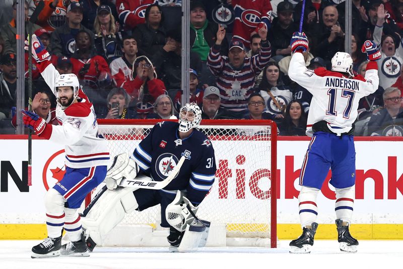 Feb 4, 2026; Winnipeg, Manitoba, CAN; Montreal Canadiens right wing Josh Anderson (17) celebrates a goal against Winnipeg Jets goaltender Connor Hellebuyck (37) in the second period at Canada Life Centre. Mandatory Credit: James Carey Lauder-Imagn Images