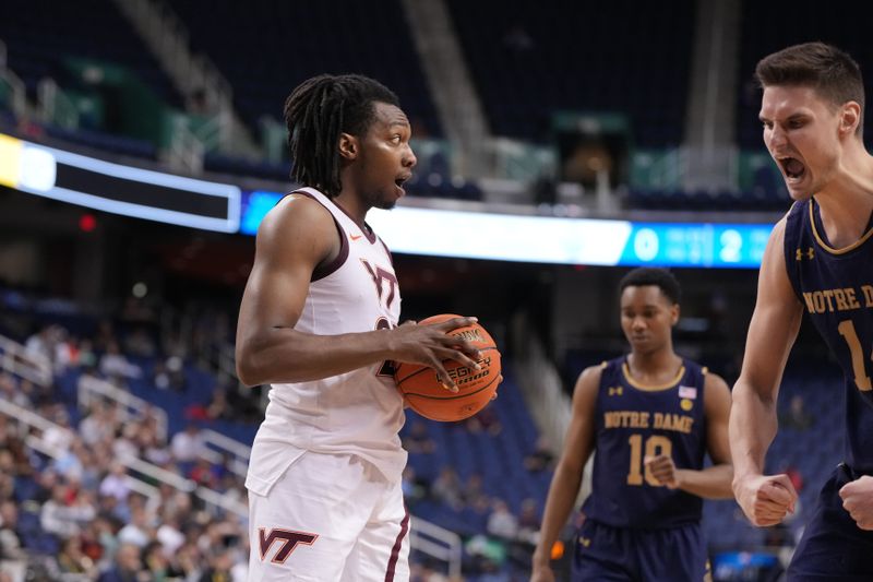 Mar 7, 2023; Greensboro, NC, USA; Virginia Tech Hokies forward Justyn Mutts (25) and Notre Dame Fighting Irish forward Nate Laszewski (14) react in the second half at Greensboro Coliseum. Mandatory Credit: Bob Donnan-USA TODAY Sports