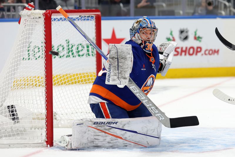 Nov 30, 2024; Elmont, New York, USA; New York Islanders goaltender Ilya Sorokin (30) makes a save against the Buffalo Sabres during the first period at UBS Arena. Mandatory Credit: Brad Penner-Imagn Images