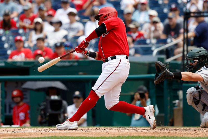 Aug 13, 2023; Washington, District of Columbia, USA; Washington Nationals shortstop Ildemaro Vargas (14) hits a single against the Oakland Athletics during the third inning at Nationals Park. Mandatory Credit: Geoff Burke-USA TODAY Sports