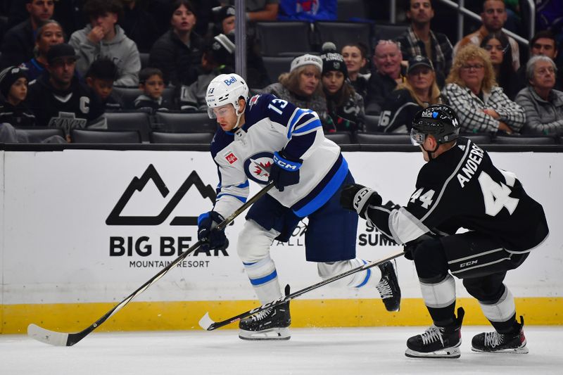 Dec 13, 2023; Los Angeles, California, USA; Winnipeg Jets center Gabriel Vilardi (13) moves the puck against Los Angeles Kings defenseman Mikey Anderson (44) during the third period at Crypto.com Arena. Mandatory Credit: Gary A. Vasquez-USA TODAY Sports