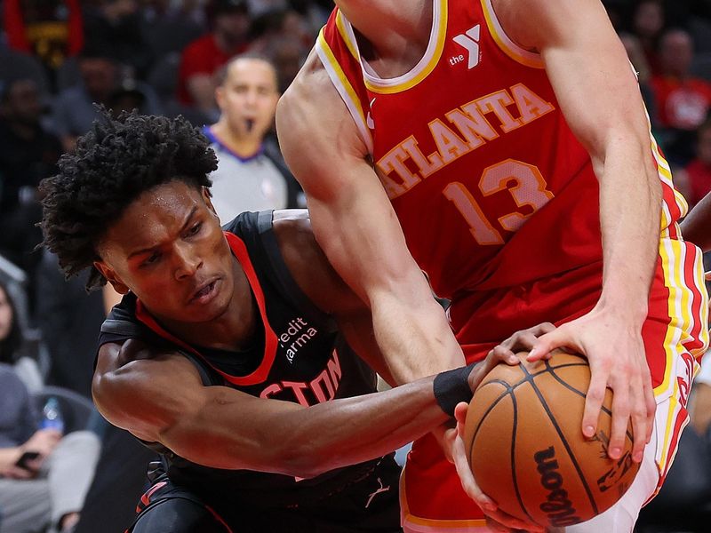 ATLANTA, GEORGIA - FEBRUARY 10:  Bogdan Bogdanovic #13 of the Atlanta Hawks draws a foul from Amen Thompson #1 of the Houston Rockets during the fourth quarter at State Farm Arena on February 10, 2024 in Atlanta, Georgia.  NOTE TO USER: User expressly acknowledges and agrees that, by downloading and/or using this photograph, user is consenting to the terms and conditions of the Getty Images License Agreement.  (Photo by Kevin C. Cox/Getty Images)