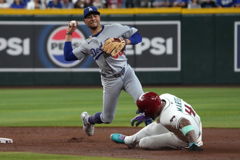 Sep 24, 2025; Phoenix, Arizona, USA; Los Angeles Dodgers shortstop Mookie Betts (50) gets the out on Arizona Diamondbacks second base Ketel Marte (4) in the third inning at Chase Field. Mandatory Credit: Rick Scuteri-Imagn Images