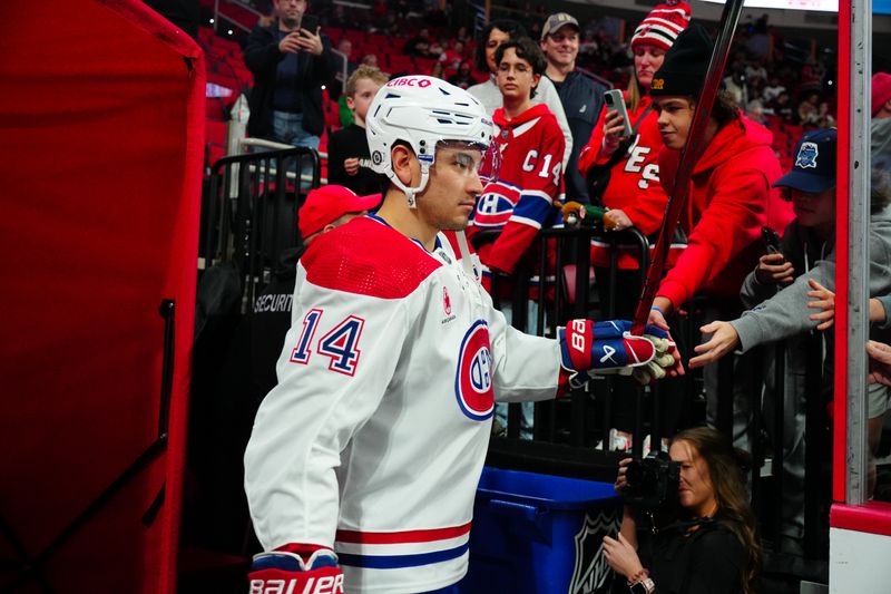 Dec 28, 2023; Raleigh, North Carolina, USA; Montreal Canadiens center Nick Suzuki (14) goes past the fans on his way to the warmups before the game against the Carolina Hurricanes at PNC Arena. Mandatory Credit: James Guillory-USA TODAY Sports