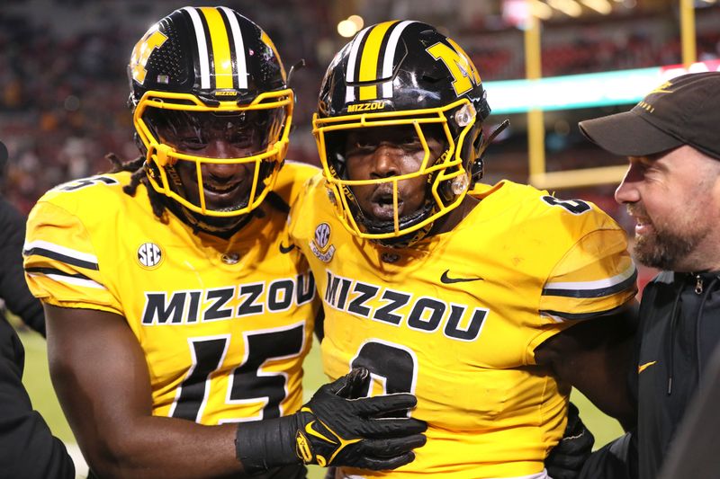 Nov 24, 2023; Fayetteville, Arkansas, USA; Missouri Tigers defensive lineman Johnny Walker Jr (15) and Jay Jernigan celebrate after a defensive touchdown by Jernigan in the third quarter against the Arkansas Razorbacks at Donald W. Reynolds Razorback Stadium. Missouri won 48-14. Mandatory Credit: Nelson Chenault-USA TODAY Sports