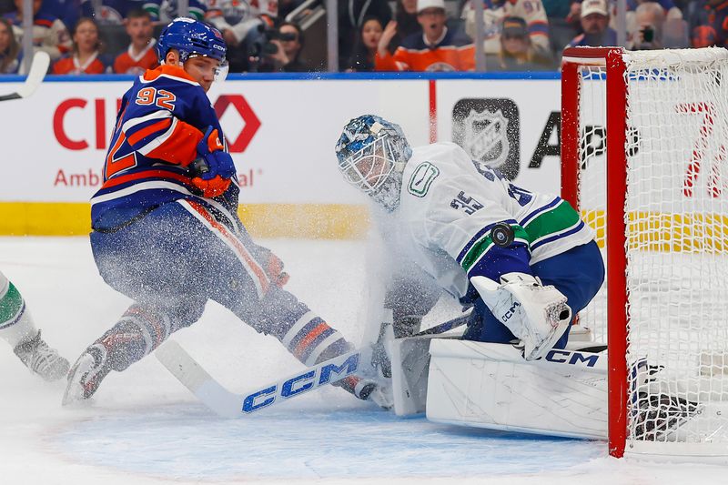 Oct 11, 2025; Edmonton, Alberta, CAN; Vancouver Canucks goaltender Thatcher Demko (35) makes a save on Edmonton Oilers forward Vasily Podkolzin (92) during the first period at Rogers Place. Mandatory Credit: Perry Nelson-Imagn Images
