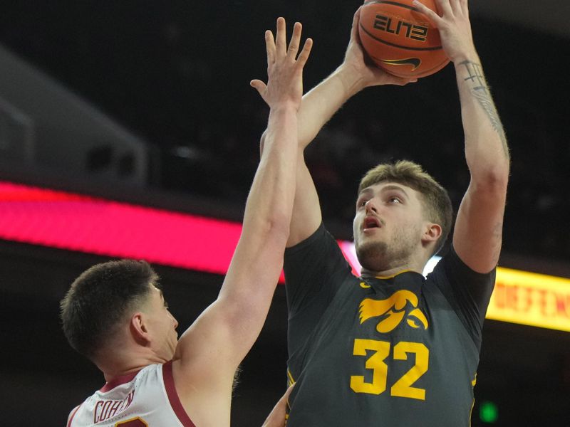 Jan 14, 2025; Los Angeles, California, USA; Iowa Hawkeyes forward Owen Freeman (32) shoots the ball against Southern California Trojans forward Josh Cohen (33) in the first half at Galen Center. Mandatory Credit: Kirby Lee-Imagn Images