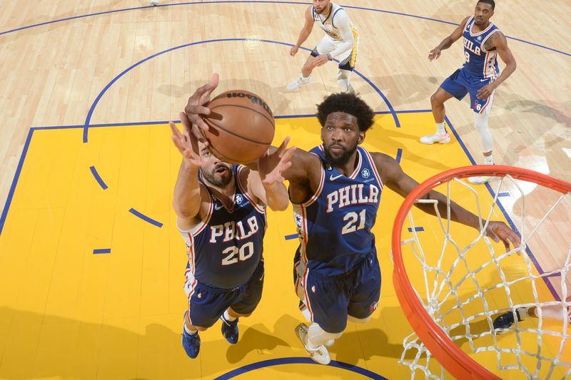 SAN FRANCISCO, CA - MARCH 24: Joel Embiid #21 of the Philadelphia 76ers grabs the rebound during the game against the Golden State Warriors on March 24, 2023 at Chase Center in San Francisco, California. NOTE TO USER: User expressly acknowledges and agrees that, by downloading and or using this photograph, user is consenting to the terms and conditions of Getty Images License Agreement. Mandatory Copyright Notice: Copyright 2023 NBAE (Photo by Noah Graham/NBAE via Getty Images)