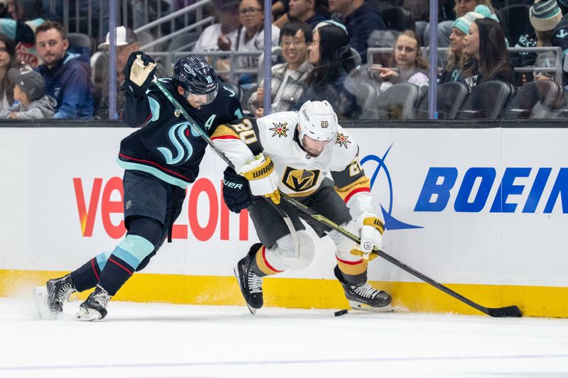 Oct 11, 2025; Seattle, Washington, USA; Seattle Kraken forward Matty Beniers (10) and Vegas Golden Knights forward Brandon Saad (20) battle for the puck during the first period at Climate Pledge Arena. Mandatory Credit: Stephen Brashear-Imagn Images