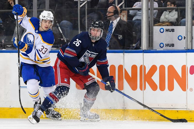 Dec 23, 2023; New York, New York, USA; Buffalo Sabres defenseman Ryan Johnson (33) and New York Rangers left wing Jimmy Vesey (26) battle for the puck during the third period at Madison Square Garden. Mandatory Credit: Dennis Schneidler-USA TODAY Sports