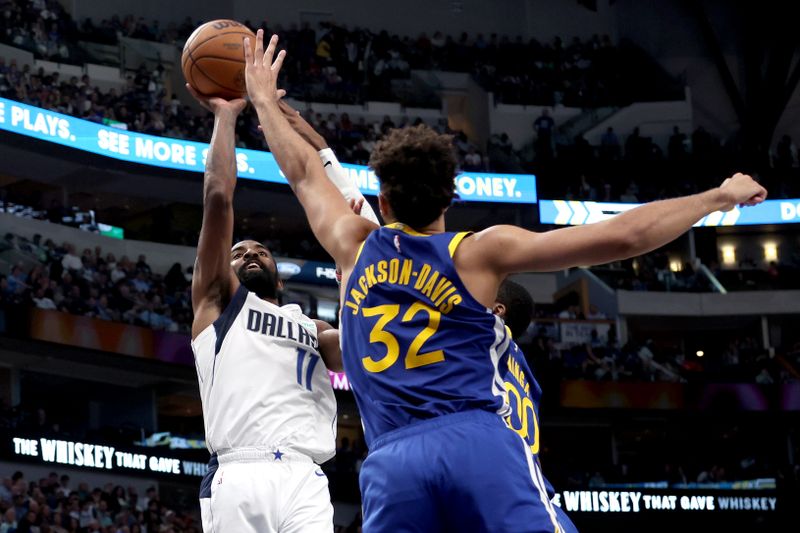 DALLAS, TEXAS - MARCH 13: Kyrie Irving #11 of the Dallas Mavericks shoots the ball against Trayce Jackson-Davis #32 of the Golden State Warriors in the first half at American Airlines Center on March 13, 2024 in Dallas, Texas. NOTE TO USER: User expressly acknowledges and agrees that, by downloading and or using this photograph, User is consenting to the terms and conditions of the Getty Images License Agreement. (Photo by Tim Heitman/Getty Images)