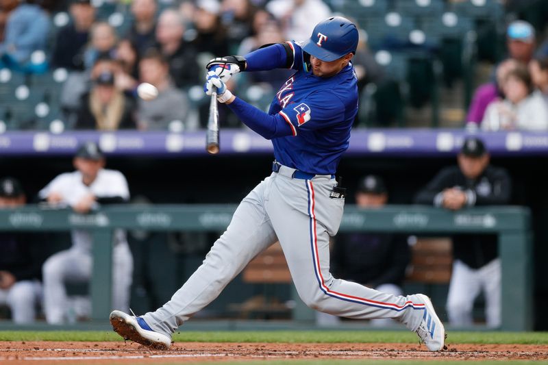 May 10, 2024; Denver, Colorado, USA; Texas Rangers shortstop Corey Seager (5) hits a double in the third inning against the Colorado Rockies at Coors Field. Mandatory Credit: Isaiah J. Downing-USA TODAY Sports