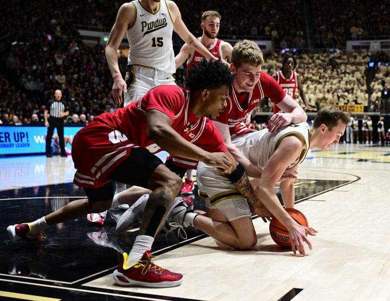 Mar 10, 2024; West Lafayette, Indiana, USA; Purdue Boilermakers guard Fletcher Loyer (2) loses control of the ball in front of Wisconsin Badgers forward Steven Crowl (22) and Wisconsin Badgers guard Kamari McGee (4) during the second half at Mackey Arena. Mandatory Credit: Marc Lebryk-USA TODAY Sports