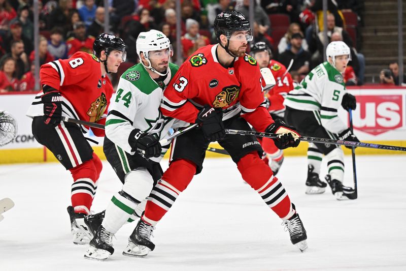 Jan 13, 2024; Chicago, Illinois, USA;  Dallas Stars defensman Joe Hanley (44) and Chicago Blackhawks forward Zach Sanford (13) battle for position in the first period at United Center. Mandatory Credit: Jamie Sabau-USA TODAY Sports