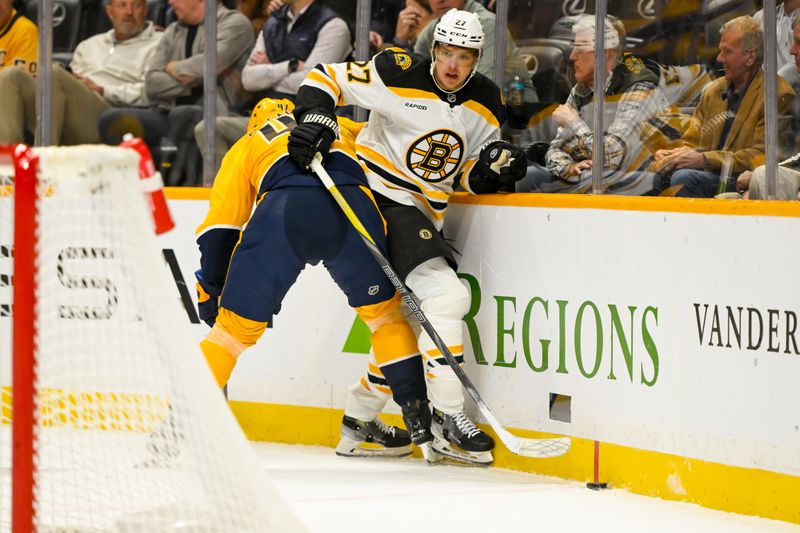 Oct 22, 2024; Nashville, Tennessee, USA;  Nashville Predators defenseman Alexandre Carrier (45) checks Boston Bruins defenseman Hampus Lindholm (27) during the first period at Bridgestone Arena. Mandatory Credit: Steve Roberts-Imagn Images