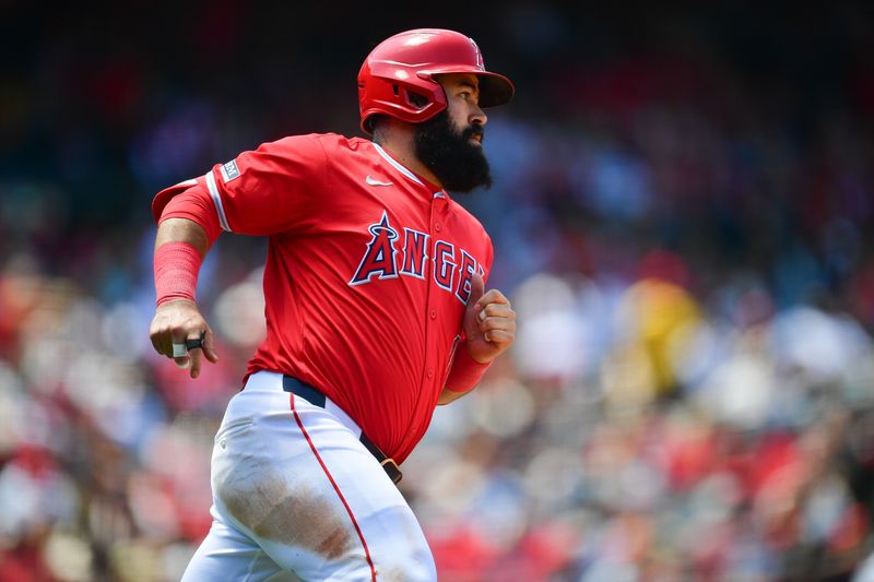 May 26, 2024; Anaheim, California, USA; Los Angeles Angels second base Luis Guillorme (15) reaches first on a single against the Cleveland Guardians during the fifth inning at Angel Stadium. Mandatory Credit: Gary A. Vasquez-USA TODAY Sports