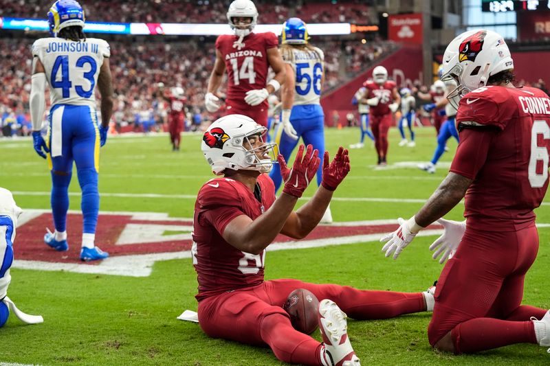 Arizona Cardinals tight end Elijah Higgins (84) celebrates his touchdown against the Los Angeles Rams during the first half of an NFL football game, Sunday, Sept. 15, 2024, in Glendale, Ariz. (AP Photo/Ross D. Franklin)