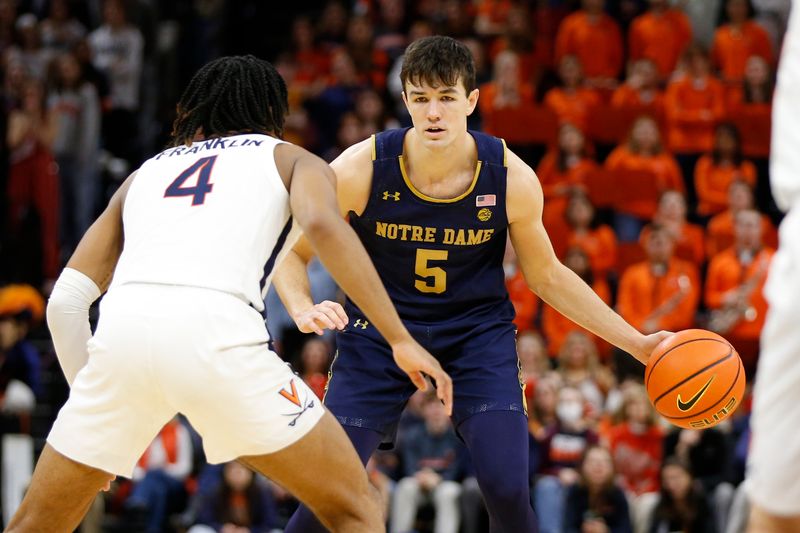 Feb 18, 2023; Charlottesville, Virginia, USA; Notre Dame Fighting Irish guard Cormac Ryan (5) controls the ball as Virginia Cavaliers guard Armaan Franklin (4) defends during the first half at John Paul Jones Arena. Mandatory Credit: Amber Searls-USA TODAY Sports