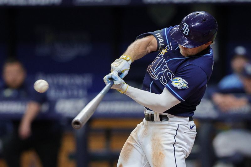 Sep 9, 2023; St. Petersburg, Florida, USA;  Tampa Bay Rays shortstop Taylor Walls (6) hits an rbi single against the Seattle Mariners in the seventh inning at Tropicana Field. Mandatory Credit: Nathan Ray Seebeck-USA TODAY Sports