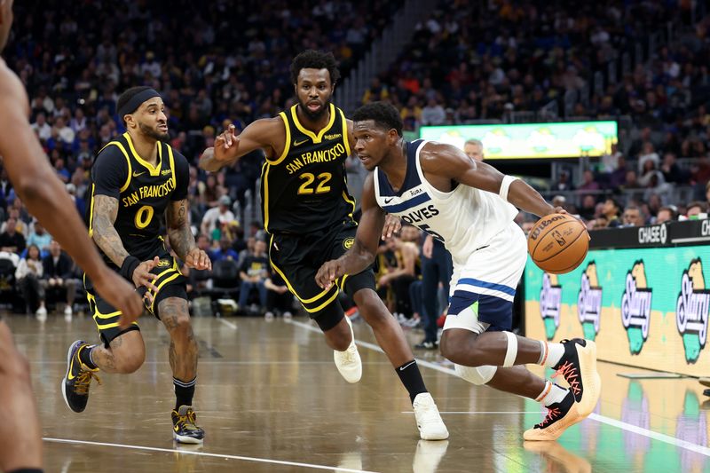 SAN FRANCISCO, CALIFORNIA - NOVEMBER 14: Anthony Edwards #5 of the Minnesota Timberwolves is guarded by Andrew Wiggins #22 and Gary Payton II #0 of the Golden State Warriors at Chase Center on November 14, 2023 in San Francisco, California. NOTE TO USER: User expressly acknowledges and agrees that, by downloading and or using this photograph, User is consenting to the terms and conditions of the Getty Images License Agreement.  (Photo by Ezra Shaw/Getty Images)