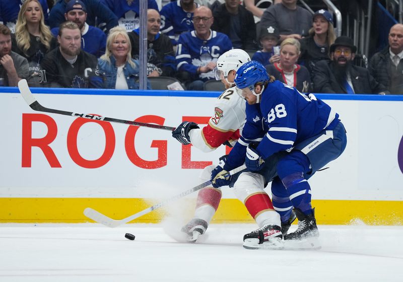 May 7, 2025; Toronto, Ontario, CAN; Toronto Maple Leafs right wing William Nylander (88) battles for the puck with Florida Panthers defenseman Gustav Forsling (42) during the first period in game two of the second round of the 2025 Stanley Cup Playoffs at Scotiabank Arena. Mandatory Credit: Nick Turchiaro-Imagn Images