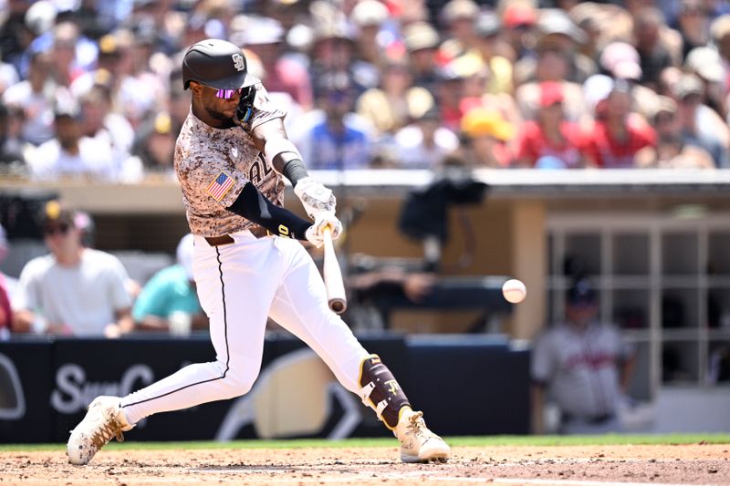 Jul 14, 2024; San Diego, California, USA; San Diego Padres left fielder Jurickson Profar (10) hits a single against the Atlanta Braves during the fifth inning at Petco Park. Mandatory Credit: Orlando Ramirez-USA TODAY Sports