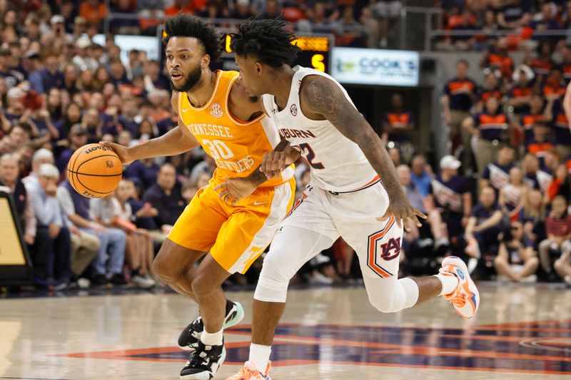 Mar 4, 2023; Auburn, Alabama, USA;  Tennessee Volunteers guard Josiah-Jordan James (30) drives in against Auburn Tigers guard Zep Jagainstper (12) during the first half at Neville Arena. Mandatory Credit: John Reed-USA TODAY Sports