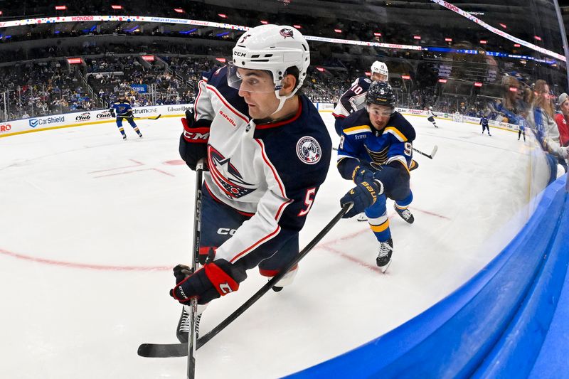 Oct 1, 2024; St. Louis, Missouri, USA;  Columbus Blue Jackets defenseman Denton Mateychuk (5) and St. Louis Blues center Alexandre Texier (9) battle for the puck during the third period at Enterprise Center. Mandatory Credit: Jeff Curry-Imagn Images