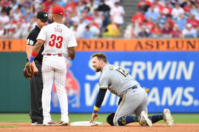 Jun 3, 2024; Philadelphia, Pennsylvania, USA; Milwaukee Brewers first base Rhys Hoskins (12) steals second base against the Philadelphia Phillies shortstop Edmundo Sosa (33) during the fifth inning at Citizens Bank Park. Mandatory Credit: Eric Hartline-USA TODAY Sports