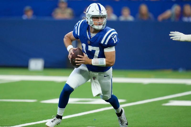 Indianapolis Colts quarterback Kedon Slovis (17) carries the ball against the Denver Broncos during the third quarter of a preseason NFL football game, Sunday, Aug. 11, 2024, in Westfield, Ind. (AP Photo/Darron Cummings)