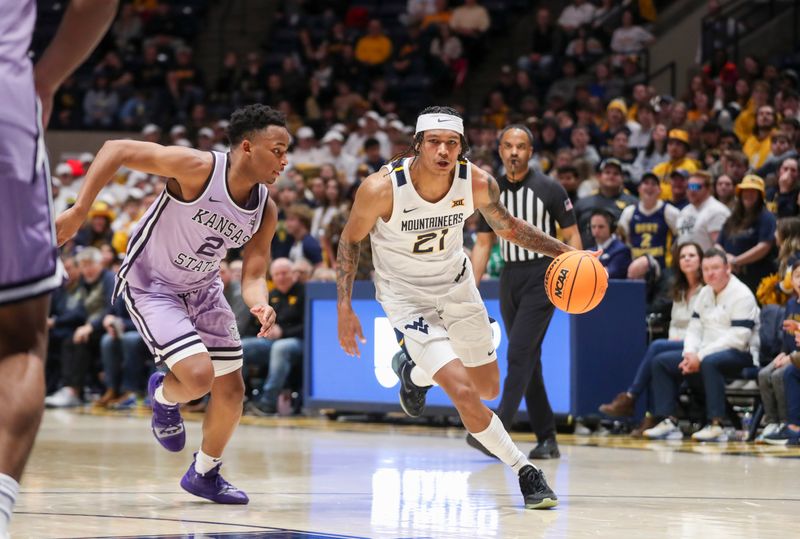 Jan 9, 2024; Morgantown, West Virginia, USA; West Virginia Mountaineers guard RaeQuan Battle (21) drives past Kansas State Wildcats guard Tylor Perry (2) during the second half at WVU Coliseum. Mandatory Credit: Ben Queen-USA TODAY Sports