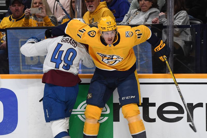 Mar 2, 2024; Nashville, Tennessee, USA; Nashville Predators right wing Michael McCarron (47) its Colorado Avalanche defenseman Samuel Girard (49) after a battle for the puck during the first period at Bridgestone Arena. Mandatory Credit: Christopher Hanewinckel-USA TODAY Sports