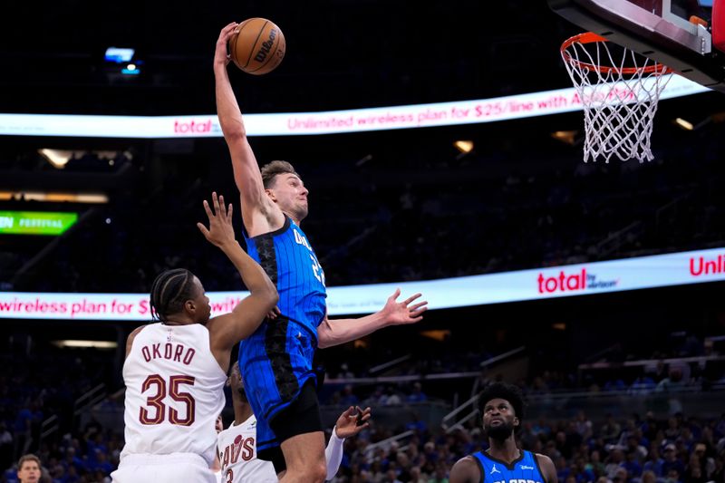 ORLANDO, FLORIDA - APRIL 25: Franz Wagner #22 of the Orlando Magic goes up for a shot against Isaac Okoro #35 of the Cleveland Cavaliers during the first quarter of game three of the Eastern Conference First Round Playoffs at Kia Center on April 25, 2024 in Orlando, Florida.  (Photo by Rich Storry/Getty Images)