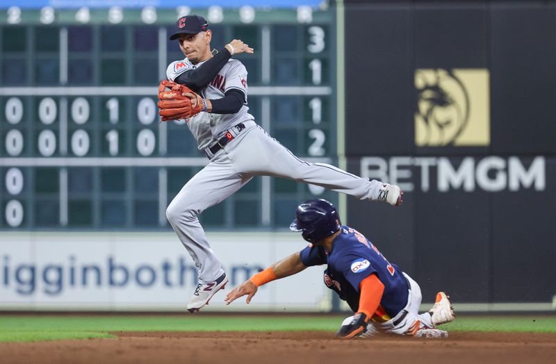 Aug 1, 2023; Houston, Texas, USA; Houston Astros shortstop Jeremy Pena (3) is out at second base as Cleveland Guardians second baseman Andres Gimenez (0) throws to first base during the fifth inning at Minute Maid Park. Mandatory Credit: Troy Taormina-USA TODAY Sports