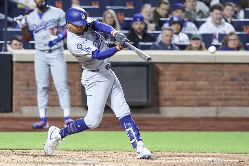 May 24, 2025; New York City, New York, USA;  Los Angeles Dodgers shortstop Mookie Betts (50) hits a single in the sixth inning against the New York Mets at Citi Field. Mandatory Credit: Wendell Cruz-Imagn Images