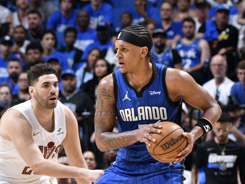 ORLANDO, FL - APRIL 27: Paolo Banchero #5 of the Orlando Magic handles the ball during the game against the Cleveland Cavaliers during Round 1 Game 4 of the 2024 NBA Playoffs on April 27, 2024 at the Kia Center in Orlando, Florida. NOTE TO USER: User expressly acknowledges and agrees that, by downloading and or using this photograph, User is consenting to the terms and conditions of the Getty Images License Agreement. Mandatory Copyright Notice: Copyright 2024 NBAE (Photo by Fernando Medina/NBAE via Getty Images)