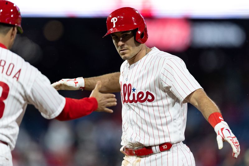 Apr 26, 2023; Philadelphia, Pennsylvania, USA; Philadelphia Phillies catcher J.T. Realmuto (10) reacts with first base coach Paco Figueroa (38) after hitting an RBI single during the eighth inning against the Seattle Mariners at Citizens Bank Park. Mandatory Credit: Bill Streicher-USA TODAY Sports