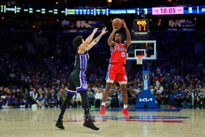 PHILADELPHIA, PENNSYLVANIA - JANUARY 12: Tyrese Maxey #0 of the Philadelphia 76ers shoots the ball against Chris Duarte #3 of the Sacramento Kings in the first half at the Wells Fargo Center on January 12, 2024 in Philadelphia, Pennsylvania. NOTE TO USER: User expressly acknowledges and agrees that, by downloading and or using this photograph, User is consenting to the terms and conditions of the Getty Images License Agreement. (Photo by Mitchell Leff/Getty Images)