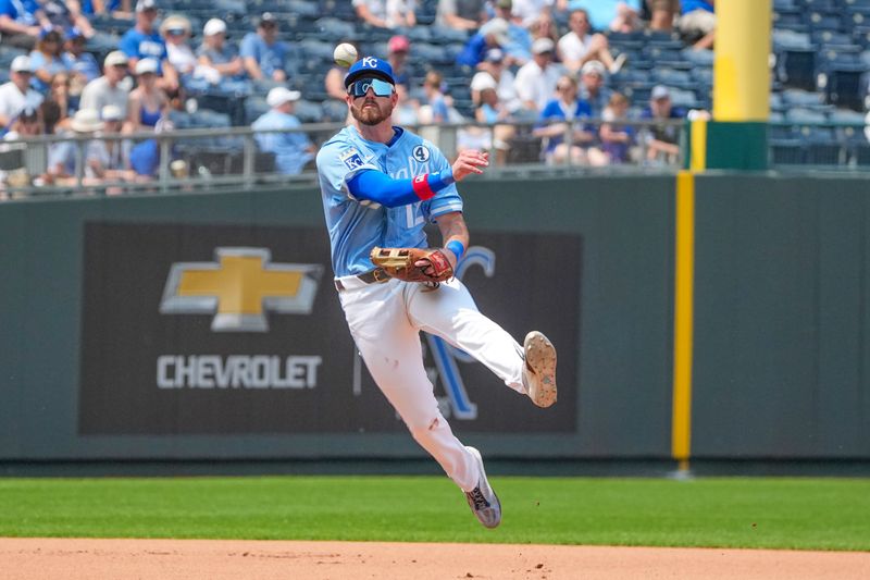 Jun 1, 2025; Kansas City, Missouri, USA; Kansas City Royals designated hitter Nick Loftin (12) fields a bal and throws to first for an out against the Detroit Tigers in the seventh inning at Kauffman Stadium. Mandatory Credit: Denny Medley-Imagn Images