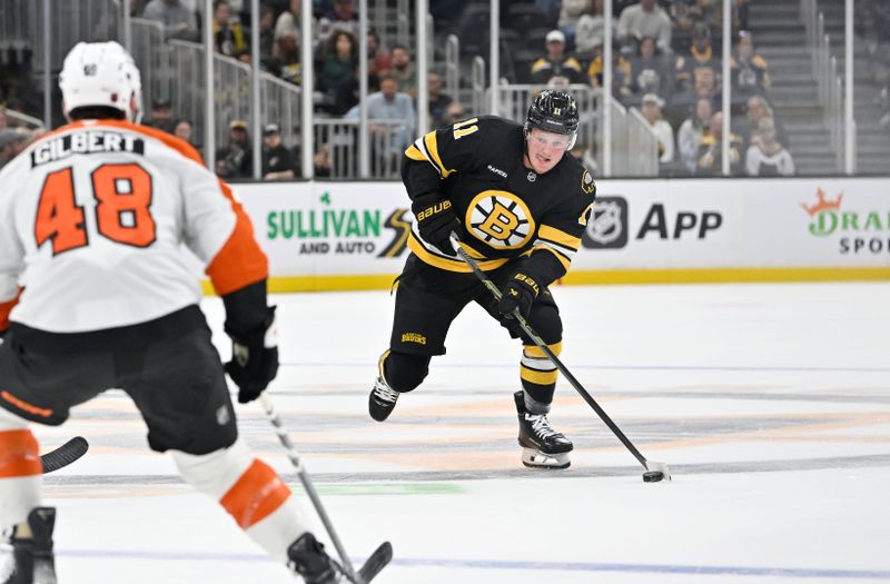 Sep 29, 2025; Boston, Massachusetts, USA;  Boston Bruins center Casey Mittelstadt (11) plays the puck through the neutral zone during the first period against the Philadelphia Flyers at TD Garden. Mandatory Credit: Eric Canha-Imagn Images