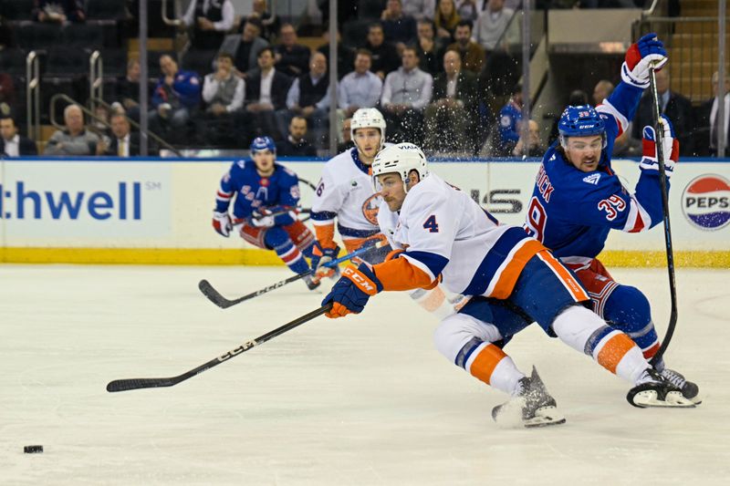 Jan 29, 2026; New York, New York, USA;  New York Rangers center Sam Carrick (39) defends against New York Islanders defenseman Carson Soucy (4) during the first period at Madison Square Garden. Mandatory Credit: Dennis Schneidler-Imagn Images
