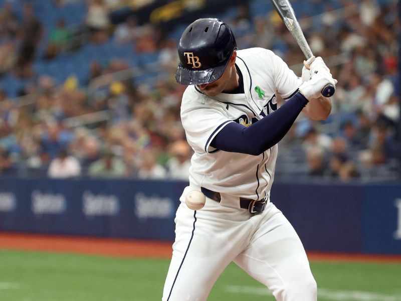 May 30, 2024; St. Petersburg, Florida, USA; Tampa Bay Rays second base Brandon Lowe (8) gets hit by a pitch against the Oakland Athletics during the eighth inning at Tropicana Field. Mandatory Credit: Kim Klement Neitzel-USA TODAY Sports