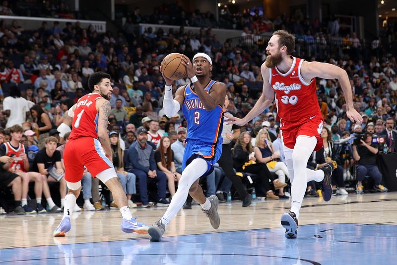 MEMPHIS, TENNESSEE - APRIL 26: Shai Gilgeous-Alexander #2 of the Oklahoma City Thunder goes to the basket against Jay Huff #30 of the Memphis Grizzlies during the second half of Game Four of the Western Conference First Round NBA Playoffs at FedExForum on April 26, 2025 in Memphis, Tennessee. NOTE TO USER: User expressly acknowledges and agrees that, by downloading and or using this photograph, User is consenting to the terms and conditions of the Getty Images License Agreement. (Photo by Justin Ford/Getty Images)