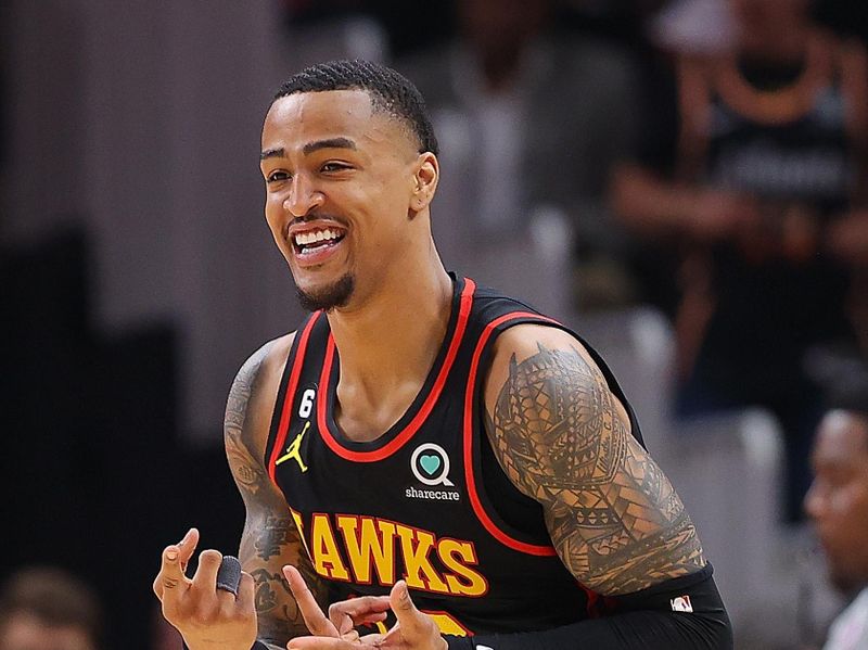 ATLANTA, GEORGIA - APRIL 21:  John Collins #20 of the Atlanta Hawks reacts after hitting a three-point basket against the Boston Celtics during the second quarter of Game Three of the Eastern Conference First Round Playoffs at State Farm Arena on April 21, 2023 in Atlanta, Georgia.  NOTE TO USER: User expressly acknowledges and agrees that, by downloading and or using this photograph, User is consenting to the terms and conditions of the Getty Images License Agreement.  (Photo by Kevin C. Cox/Getty Images)