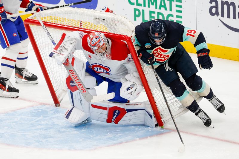 Mar 24, 2024; Seattle, Washington, USA; Seattle Kraken left wing Jared McCann (19) collides with the net with Montreal Canadiens goaltender Cayden Primeau (30)  during the third period at Climate Pledge Arena. Mandatory Credit: Joe Nicholson-USA TODAY Sports