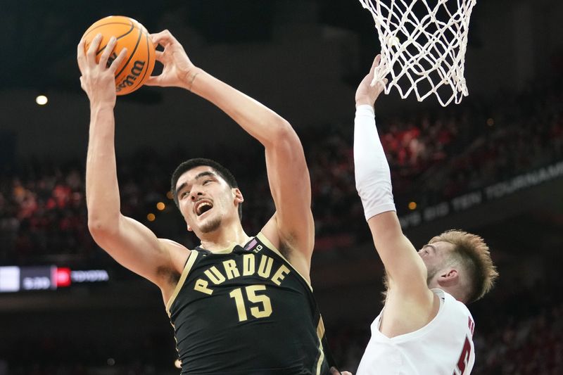 Feb 4, 2024; Madison, Wisconsin, USA; Purdue Boilermakers center Zach Edey (15) rebounds the ball against Wisconsin Badgers forward Tyler Wahl (5) during the second half at the Kohl Center. Mandatory Credit: Kayla Wolf-USA TODAY Sports