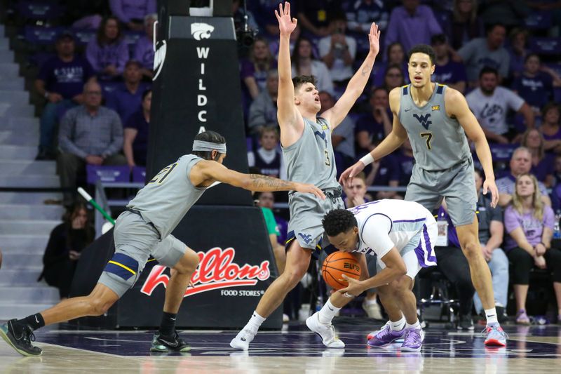 Feb 26, 2024; Manhattan, Kansas, USA; Kansas State Wildcats guard Tylor Perry (2) tries to dribble against West Virginia Mountaineers guard Kerr Kriisa (3) and guard RaeQuan Battle (21) during overtime at Bramlage Coliseum. Mandatory Credit: Scott Sewell-USA TODAY Sports